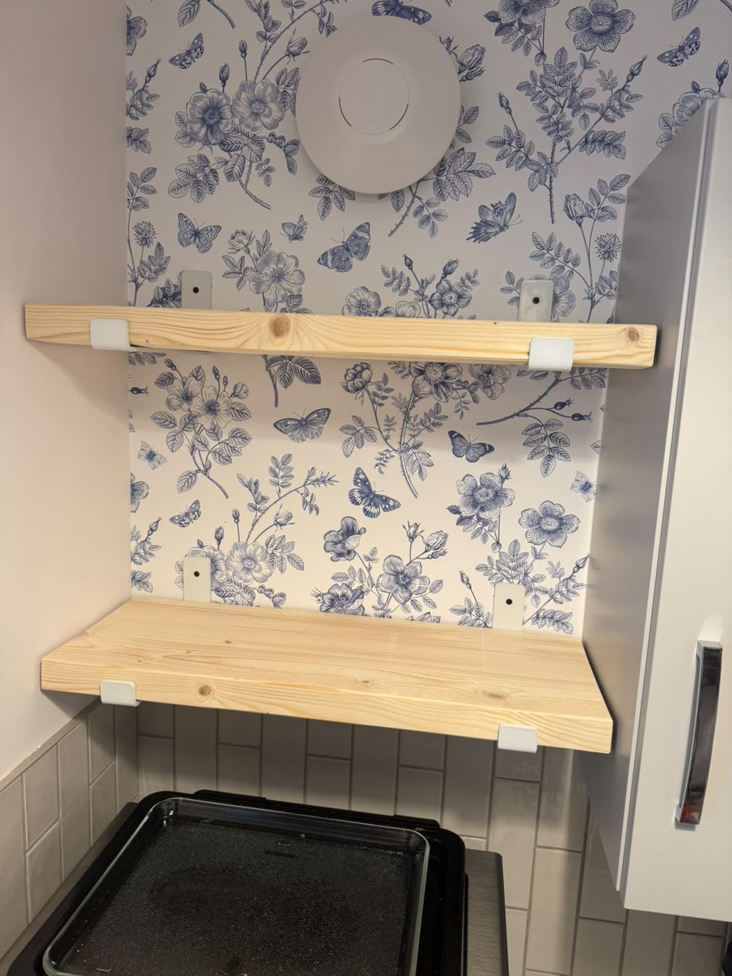 Chunky handmade timber shelves on brackets above a kitchen worktop