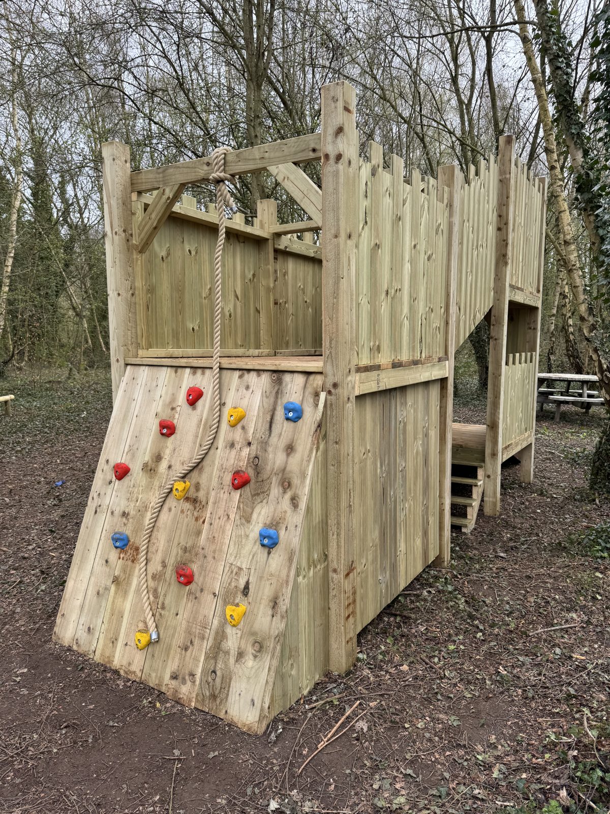 Children's play castle with climbing wall
